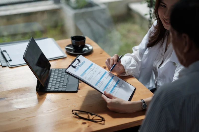 Addiction rehab doctor reviewing treatment costs and insurance coverage with a patient