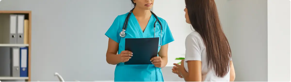 Healthcare professional discussing dual diagnosis treatment plan with patient in a clinical setting